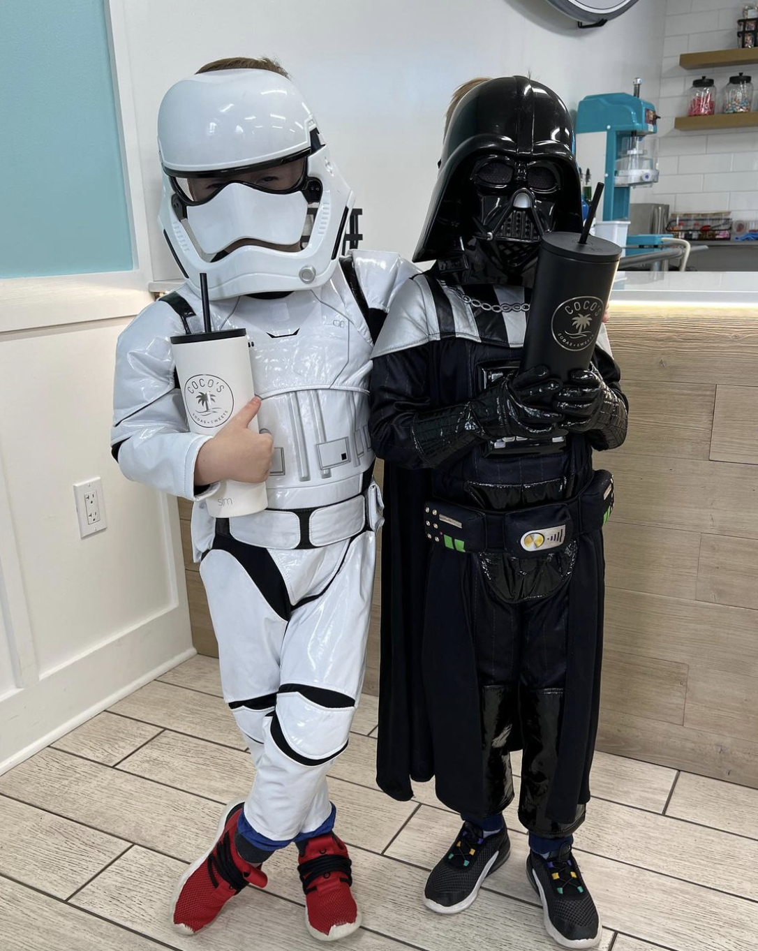 Picture of two kids in Star Wars costumes holding Coco's tumblers.